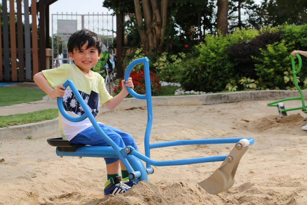 Hong Kong Gold Coast Hotel Kültér fotó A child playing with a sandbox digger
